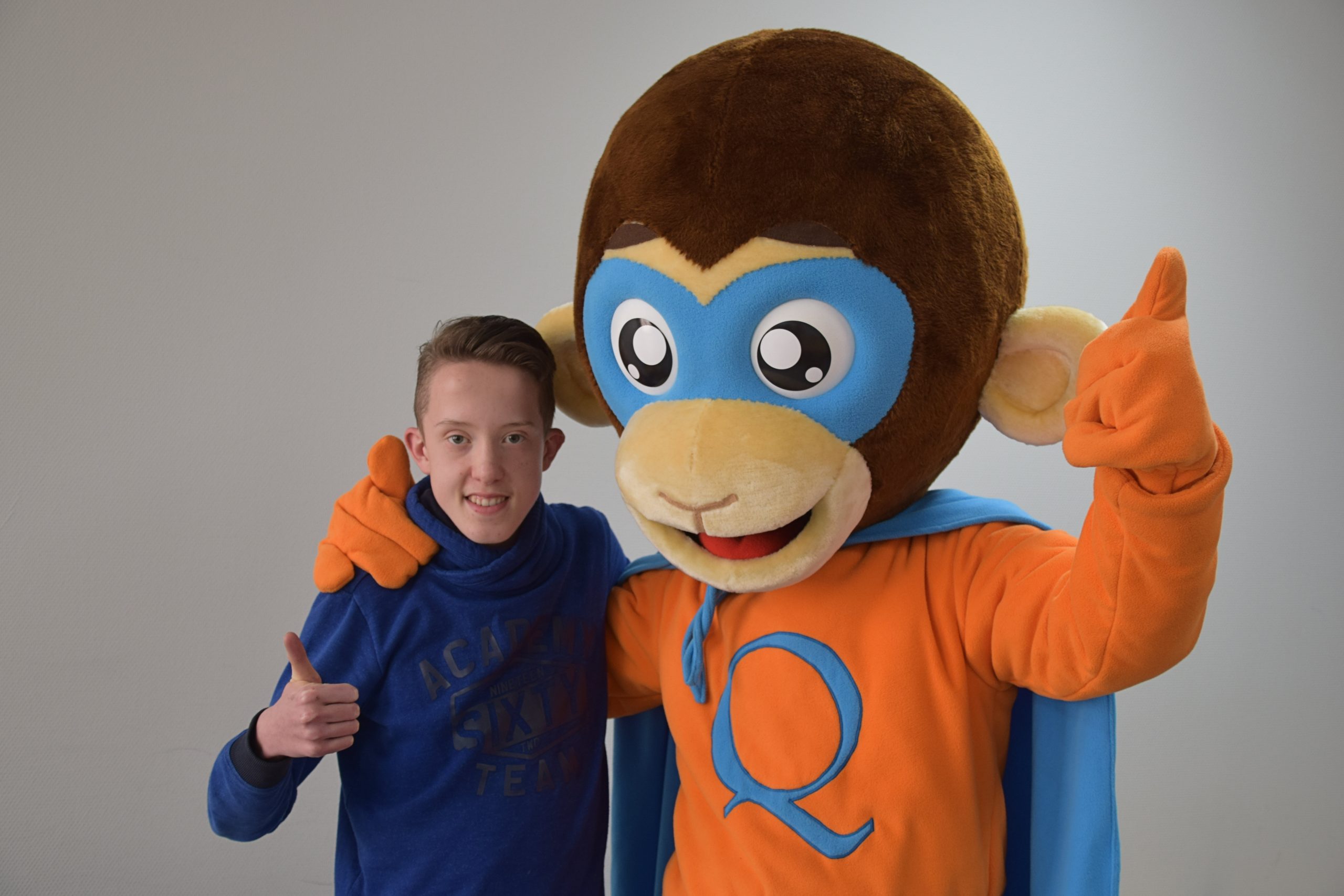 Mascotte superaap Sammie en jongen met 22q11 met een duimpje omhoog